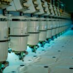Row of industrial sewing machines in a textile factory